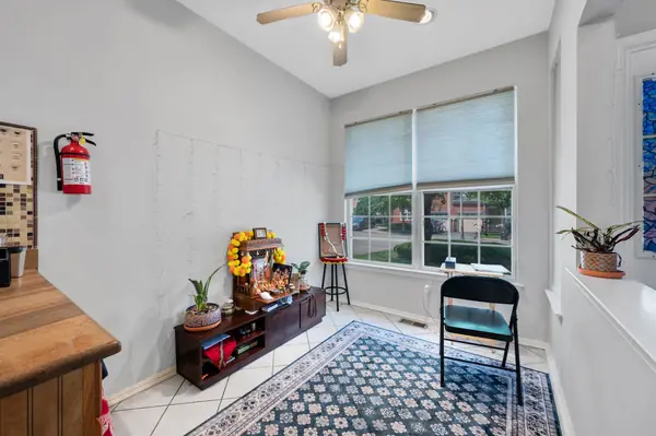 Breakfast room off the kitchen with tile floor and front-facing window