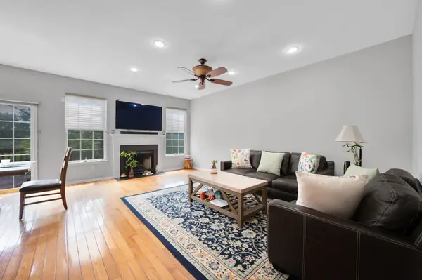 Living room with hardwood floors and tall windows