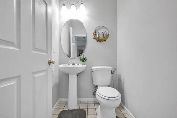 First-floor powder room with pedestal sink