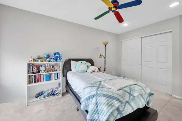 Bedroom with double closet and bookshelf
