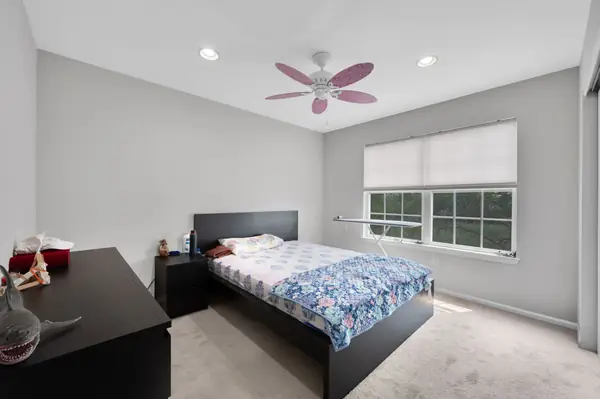 Third bedroom with ceiling fan and window blinds