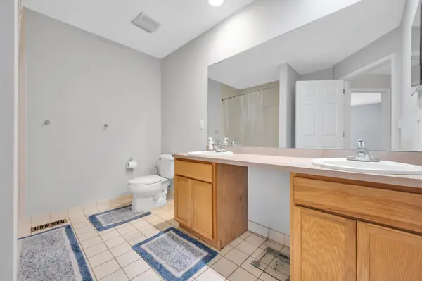 Full bathroom with double vanity and tile flooring