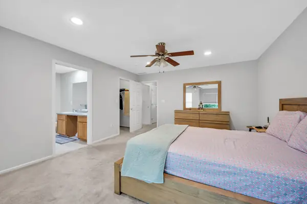 Primary bedroom with en-suite bath and walk-in closet