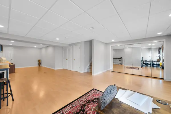 Finished walkout basement with recreation space and mirrored wall