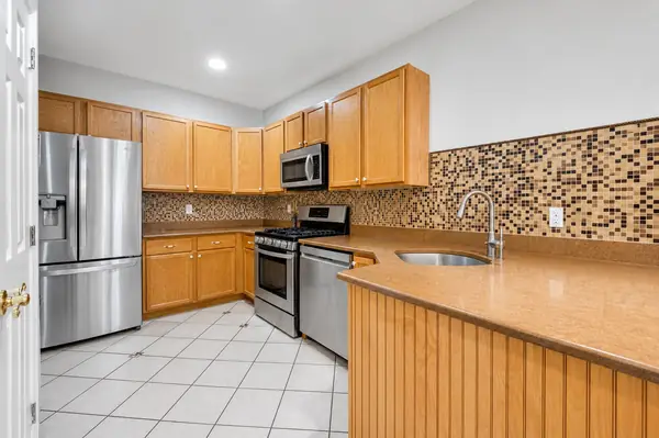 Kitchen from the breakfast bar with full appliance suite